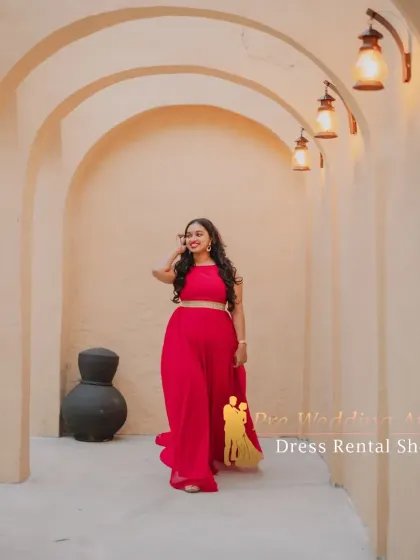 A vibrant red crop top and palazzo pants set with a small, flowing trail. This is a modern, comfortable, and stylish option for a pre-wedding shoot.