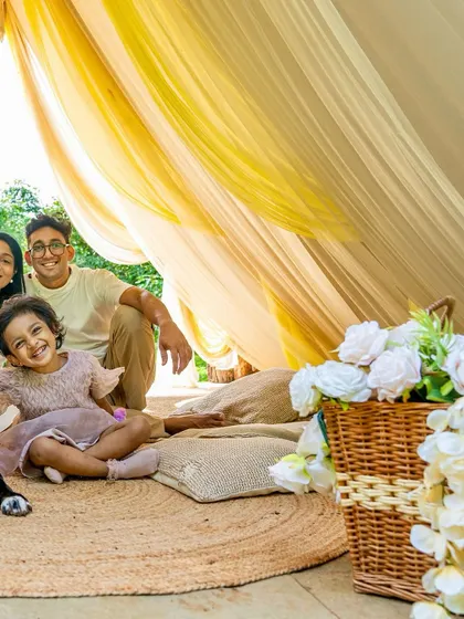 A happy family moment inside a beautifully decorated tent for their daughter's birthday.
