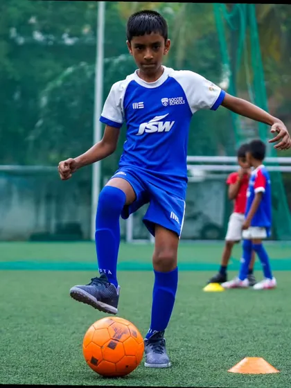 A young player stands over the ball, ready to make his next move. Our sessions build confidence and composure on the ball.