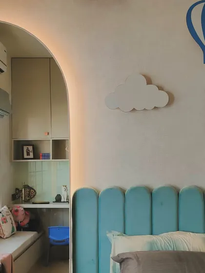 A close-up of the kid's room, showing the arched entryway to the study nook and the playful wall decor.