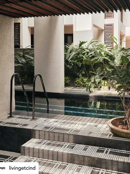 The pool area, with its graphic mosaic tiles and lush surrounding plants. This space was designed to be a private, urban oasis.