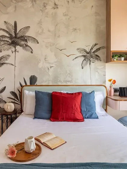 In this master bedroom, we blended romance and functionality. A custom botanical wallpaper creates a stunning feature wall, while the integrated study nook makes the most of a compact layout, proving that you never have to sacrifice style for practicality.