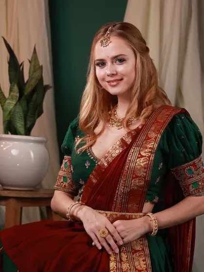 A classic portrait from the same series, with the model looking directly at the camera with a gentle smile. The rich colors of her outfit pop against the elegant backdrop.