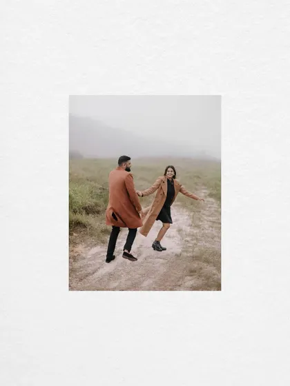 A minimalist composition featuring the couple walking hand-in-hand on a misty path in Meghalaya. The simplicity of the shot emphasizes their connection and the feeling of embarking on a journey together.