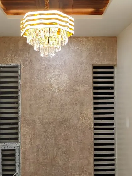 A different angle of the elegant textured wall, showing how it interacts with the room's lighting and architectural details. This type of finish is perfect for adding character to hallways or living areas.