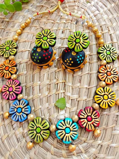 A sleek multi-color floral necklace with matching large jhumkas. This is a perfect set for customers who want a coordinated, vibrant look.