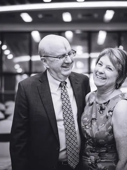 A joyful black and white portrait of an older couple, guests at the wedding, sharing a sweet moment. We believe in capturing the love stories of all your guests.
