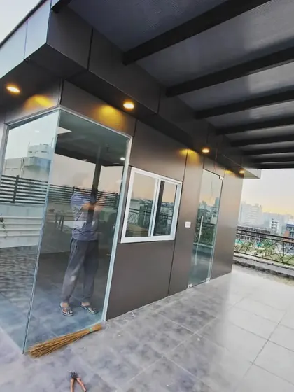 The same modern prefab room at night, with exterior lights highlighting its clean lines and contemporary design.