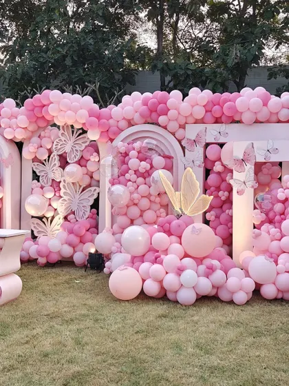 We created this breathtaking wall of pink balloons for an unforgettable outdoor event. This massive installation features thousands of balloons in varying shades and sizes, accented with intricate butterfly cutouts to create a stunning, textured backdrop perfect for photos.