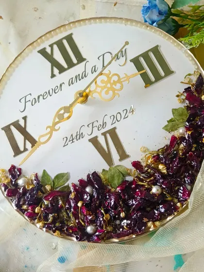 This preservation clock features the phrase "Forever and a Day" and a beautiful arrangement of deep purple flowers. It's a romantic and timeless piece to remember your special day.