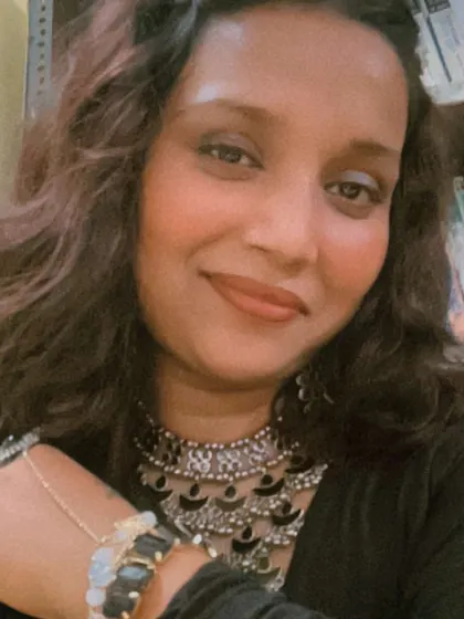 A close-up showing the details of my look for a festive event. It's the little things, like the right jewelry and a happy smile, that complete the look and get me in the zone to host a fantastic party.