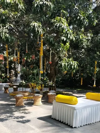 A different Haldi setup, with bright yellow cushions and simple marigold hangings, creating a cheerful and comfortable space for the ceremony.