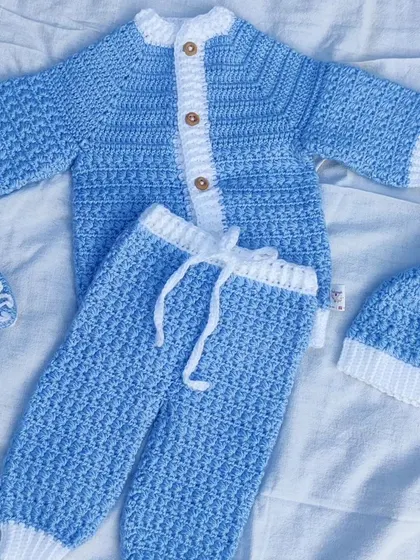A complete newborn baby set, made with so much love. This custom order includes a cozy cardigan, matching pants, a pom-pom hat, and tiny booties. I only use the softest, baby-friendly yarn to make sure it's gentle on delicate skin.