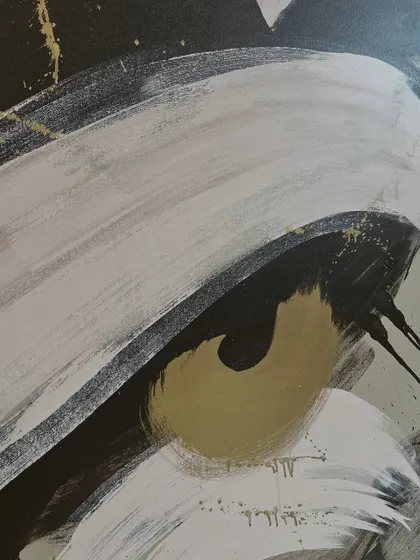 A close-up of the calligraphic abstract piece. You can see the texture of the brush and the splatters of gold paint that add a touch of sparkle.