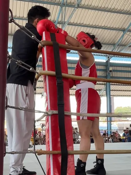 A female fighter from our academy getting ready in the corner during the 2nd Open National Championships. We train our women to be fierce competitors.