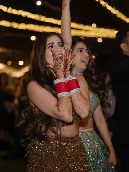 The bride, full of excitement and joy, enjoying the dance floor with her friends.