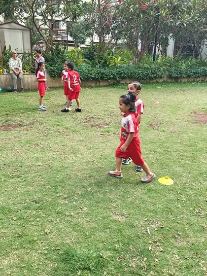A wide view of our football class in a residential green space. This shows how we utilize available areas to conduct effective and fun training sessions close to home for our students.