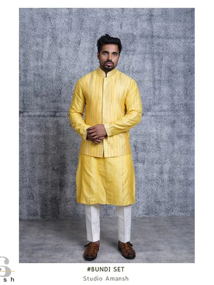 Our canary yellow bundi set is made for vibrant celebrations like a haldi ceremony. The jacket and kurta feature delicate gota embroidery for a touch of traditional shine.