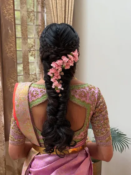 The final look of the pink floral fishtail braid. This style is perfect for an engagement or daytime wedding event, offering a fresh and modern bridal look.