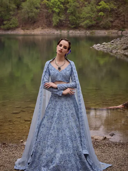 A captivating blue lehenga from the Que Sera Sera collection by Varun Chakkilam. The intricate embroidery and flowing cape create a look that is both mystical and beautiful.