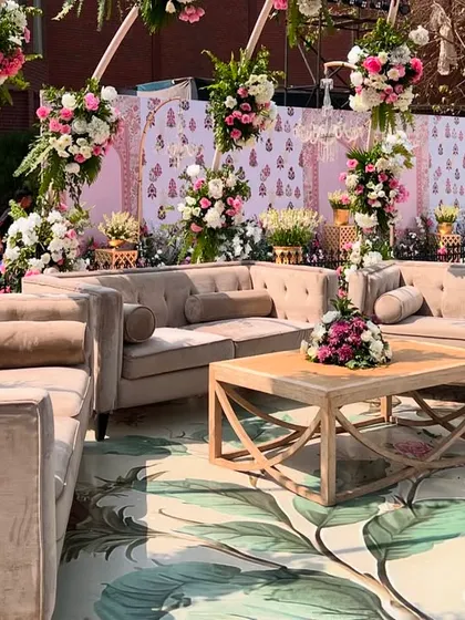 A cozy lounge seating area with a custom-printed lotus-themed carpet and plush velvet sofas for guests to relax.