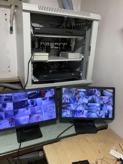 A clean and organized security setup is crucial for reliability. This is the final monitoring station for a large commercial client, featuring a professionally organized server rack and a dual-monitor setup for comprehensive surveillance of the entire premises.
