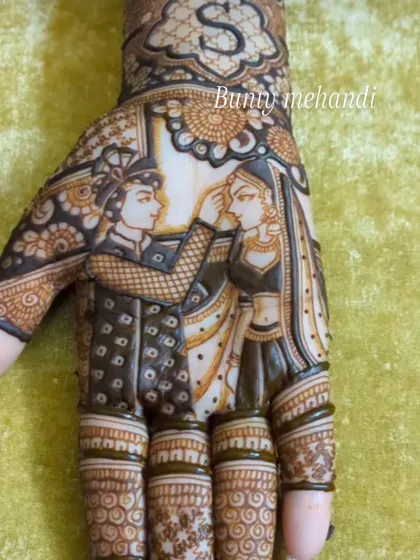 A close-up of a groom applying sindoor to his bride, a key moment in a Hindu wedding ceremony, captured forever in henna. The initial 'S' is also included above the portrait.