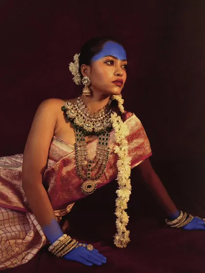 A conceptual beauty shot combining traditional Indian aesthetics with bold, artistic body paint. The rich colors and textures create a visually stunning portrait.