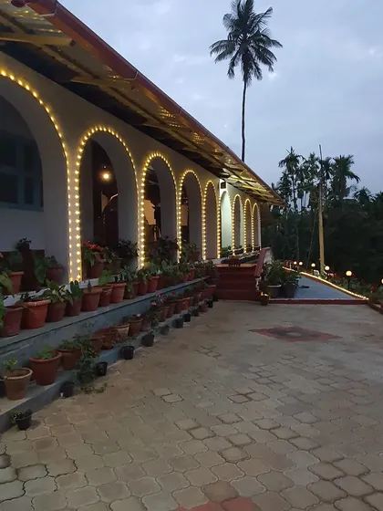 For Ananya and Rakshith's engagement in Malnad, we highlighted the venue's beautiful architecture by lining the arches with warm fairy lights. This simple touch added a magical glow to the traditional home setting.