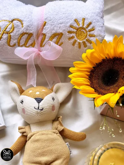 A close-up of the personalized towel embroidered with 'Raha' and a sun, part of the sunshine-themed hamper for Alia Bhatt's daughter.