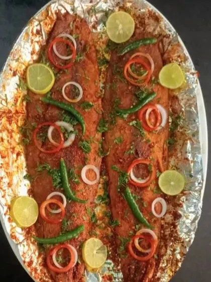 Tandoori Seer Fish, a showstopper for any event. The whole fish is marinated in tandoori spices and yogurt, then cooked until tender and flaky.