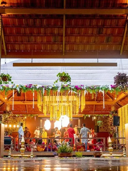 The full expanse of the wedding venue, showcasing the traditional architecture complemented by our custom decor, including pillar wraps and floral arrangements.