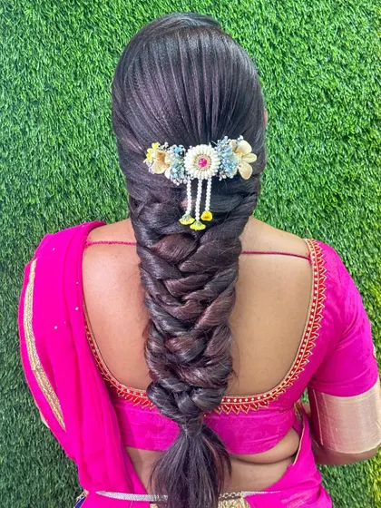 A complete makeover includes beautiful hair. In my course, we cover over 15 professional hairstyles, like this intricate South Indian braid, ensuring my students can deliver a full package to their clients.