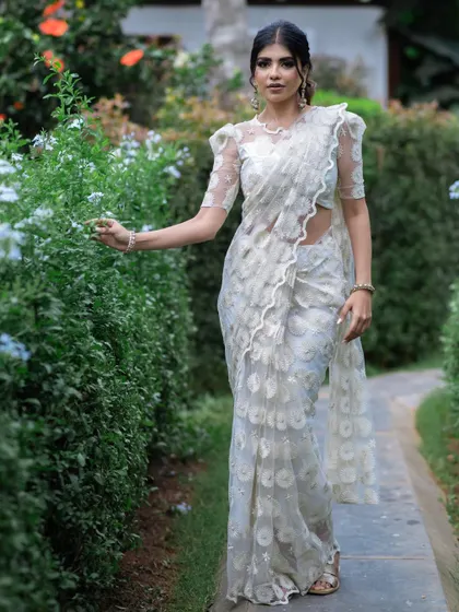 Another view of the white self-embroidered saree, a testament to its timeless design.