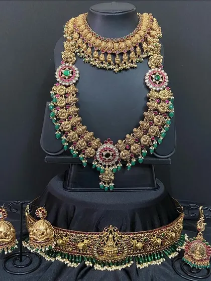 Another view of the floral haaram set, showing the beautiful jhumkas and maang tikka that complete the look. All pieces are available for rent.