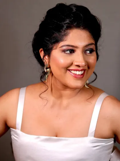 Another smiling portrait, showing how the makeup looks beautiful and natural.