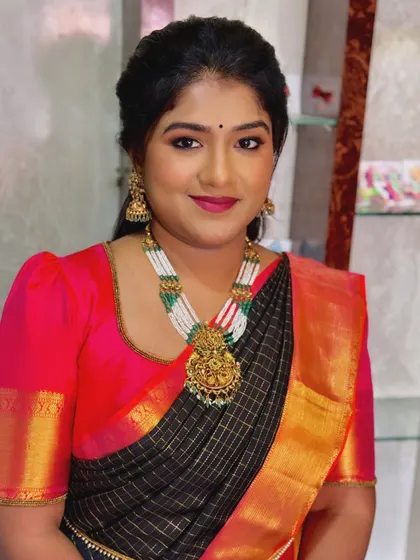 Priya looking directly at the camera, confident and beautiful for her event.