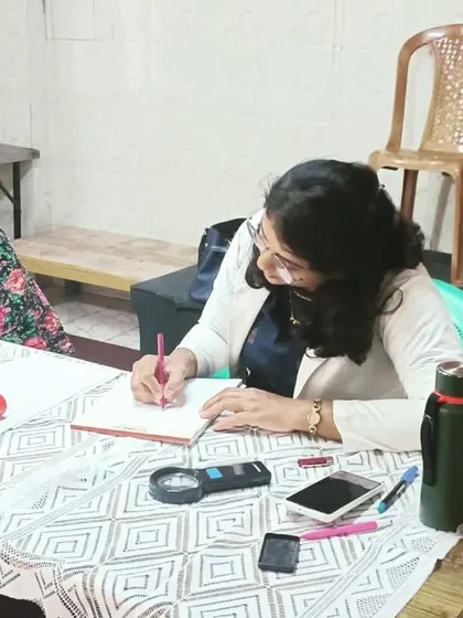 Taking notes during a patient consultation at a community camp.