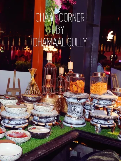 My chaat corners are designed to be a visual delight. This setup uses rustic, hand painted pottery and tiered stands on a bed of green, creating an inviting and artistic food station.