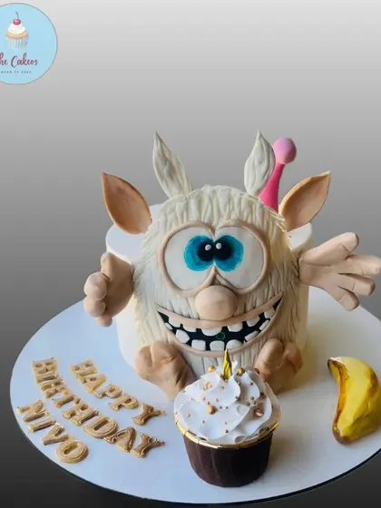 A front view of the impressive 3D sculpted Booba cake, showing off the character's wide eyes and happy expression.