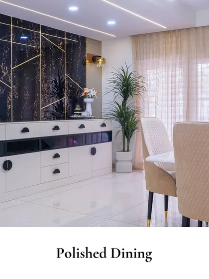This "Polished Dining" space features a dramatic black marble wall with gold inlay, a sleek white and black sideboard, and comfortable upholstered chairs. The design offers a timeless aesthetic that is both luxurious and inviting.
