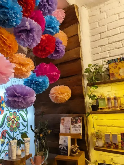 A close-up of the festive decor inside the salon. The colorful pom-poms and thoughtfully arranged product shelves create a cheerful and inspiring atmosphere.