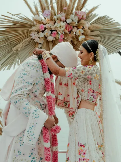 The jaimala ceremony, a beautiful and significant moment in an Indian wedding. We captured this exchange between Disha and Herin with a focus on their happy connection.
