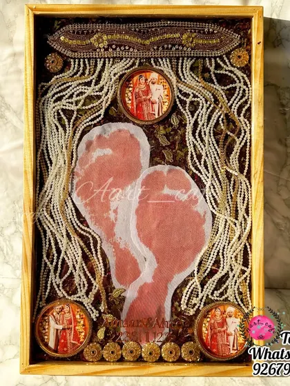A full view of the 'griha pravesh' footprint preservation frame. It's a beautiful way to capture the moment a bride enters her new home for the first time.