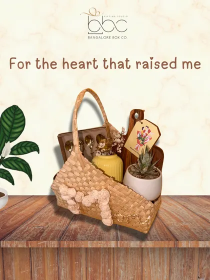 For the heart that raised me. This unique Mother's Day gift includes a stylish handcrafted bag, a succulent plant, and other curated items, all thoughtfully arranged.