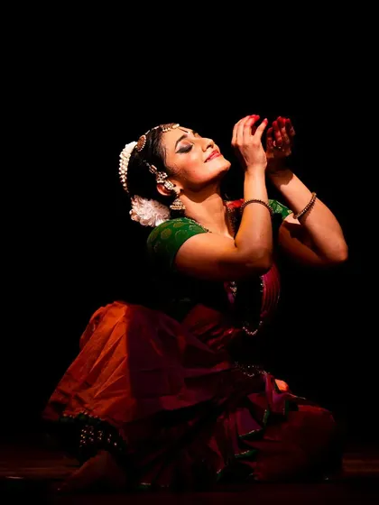 A moment of deep devotion and offering, captured at the Narada Gana Sabha. The flower becomes an extension of the emotion.