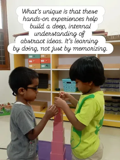 These hands-on experiences help build a deep, internal understanding of abstract ideas. Here, two children collaborate on building the Pink Tower, learning about dimension and sequence through teamwork. It's learning by doing, not by memorizing.