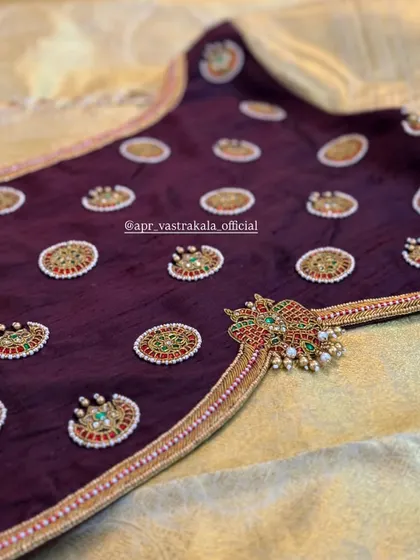 A closer look at the intricate back motif on the wine-colored blouse.
