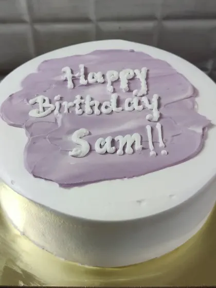 A minimalist Korean-style cake with a simple "Happy Birthday Sam!!" message on a purple brushstroke background.