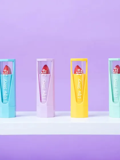 A clean, simple lineup of four pastel-colored lipsticks. This type of shot is great for showcasing different shades in a product line.